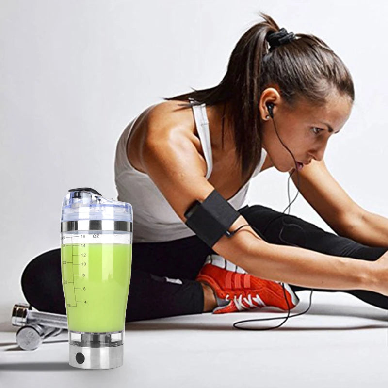 A lady using electric protein shaker bottle at the gym