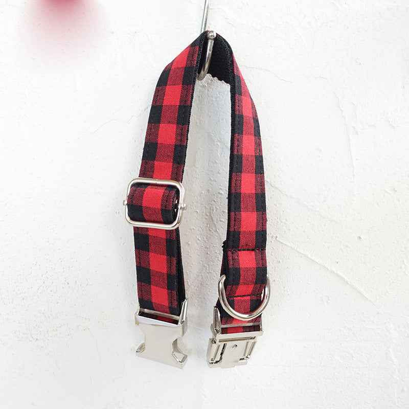 Red and black grid adjustable dog collar with metal buckle, shown hanging