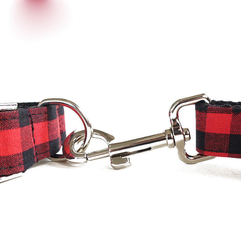 Close-up view of red and black grid dog leash with metal clip attachment