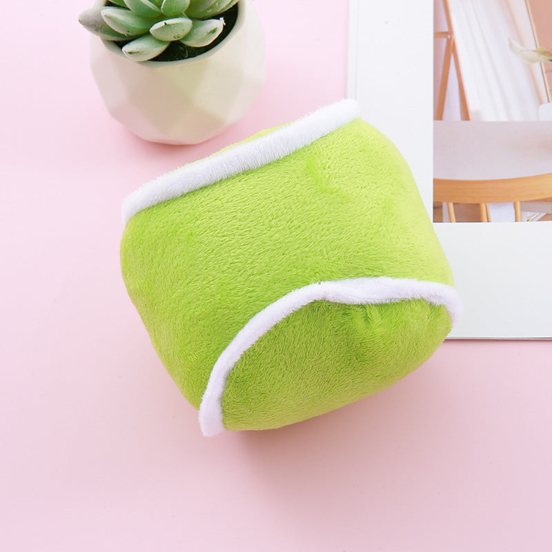 Close-up of green olive-shaped simulation dog toy