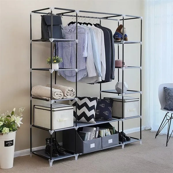 Grey portable closet frame with clothes hanging and folded items on shelves