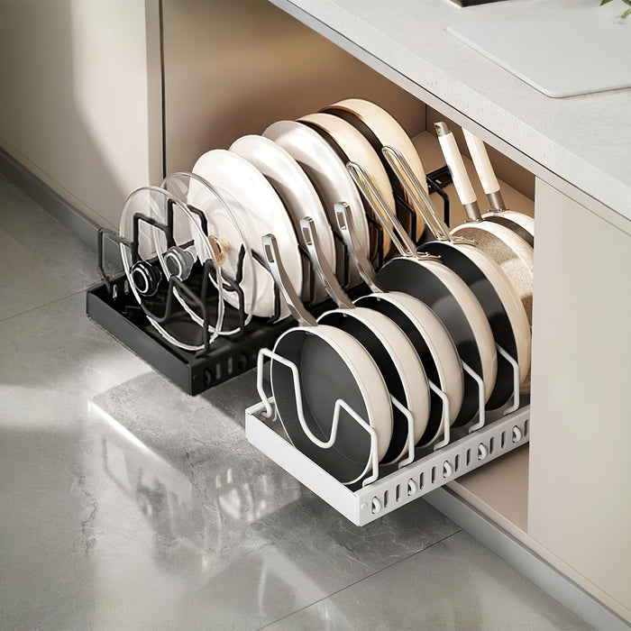 Pull-out organizer holding pans and lids upright inside a kitchen cabinet