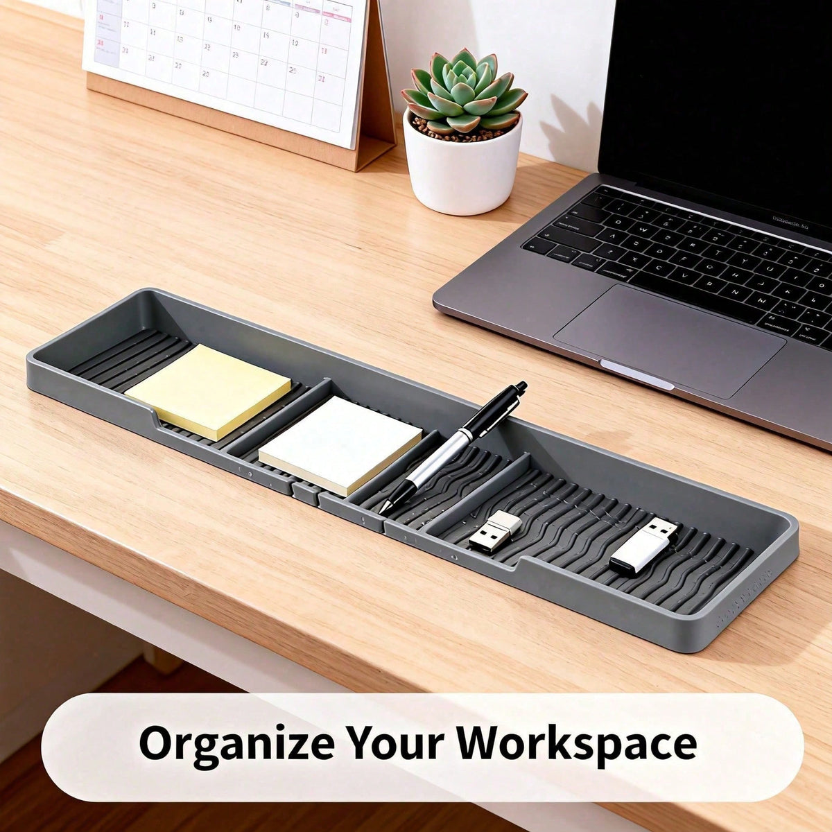 Grey silicone tray on a desk holding sticky notes, pens and a USB drive