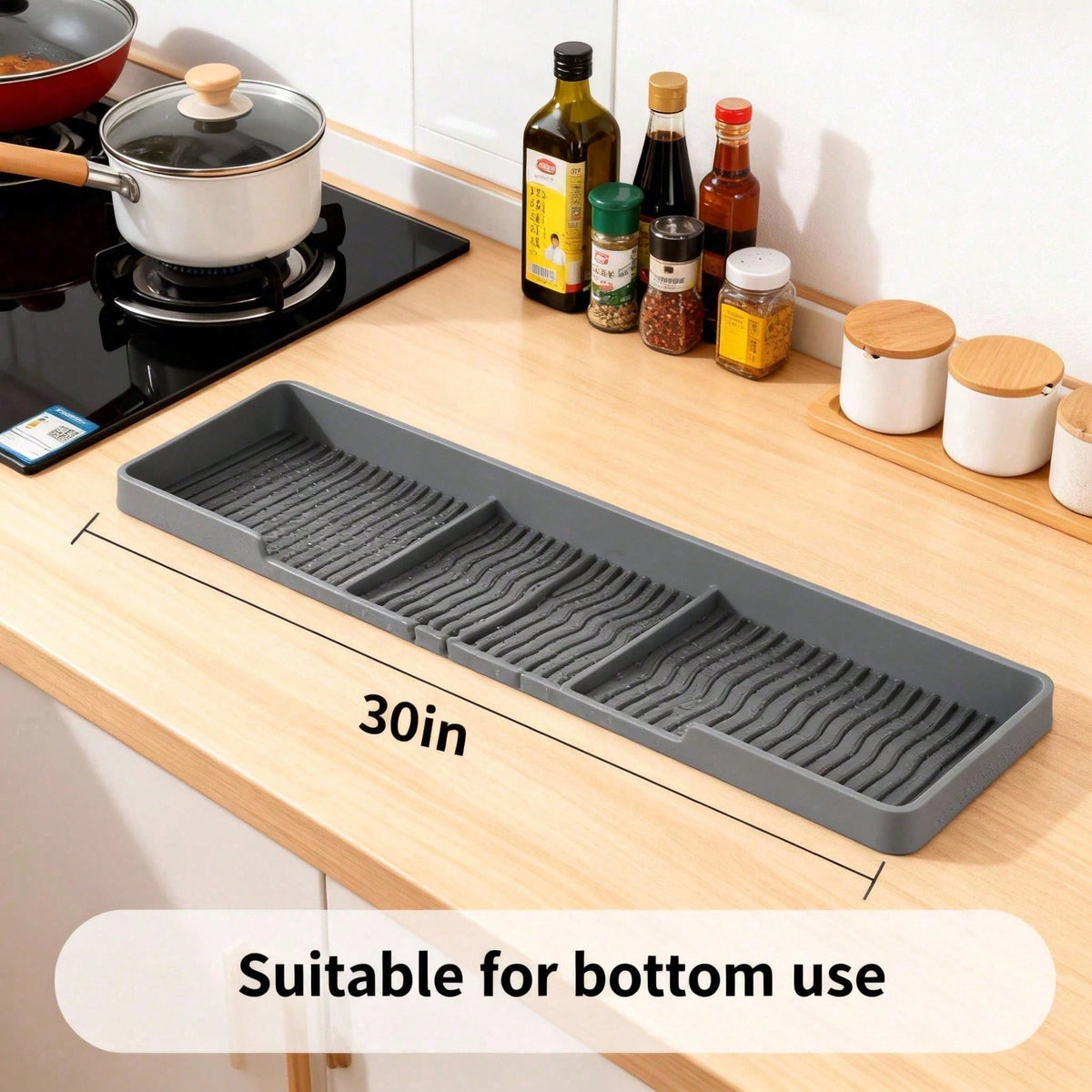 Grey silicone stove top shelf on a counter, marked 30 inches long