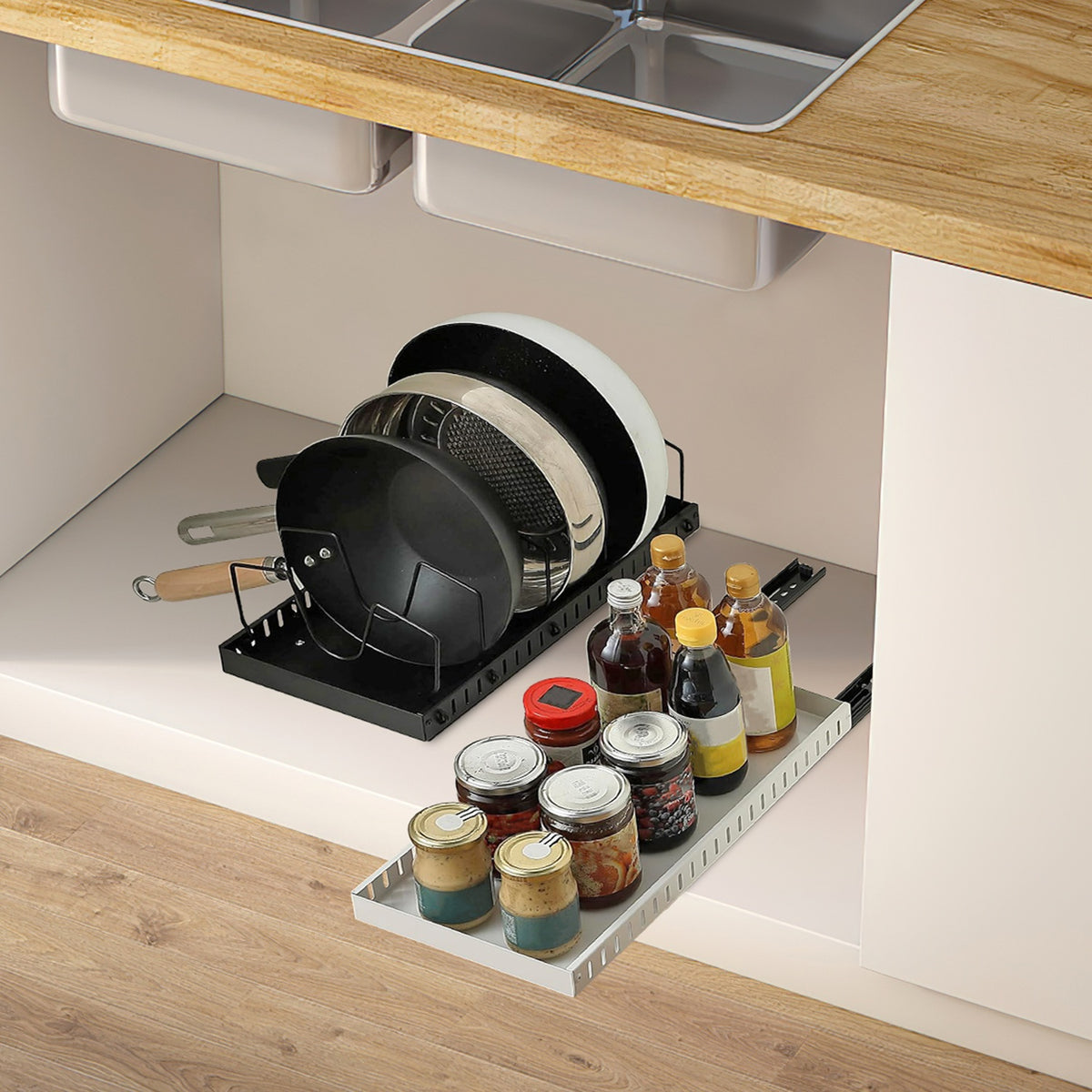 Organizer slid out of a low cabinet holding pans, with a second tray of jars