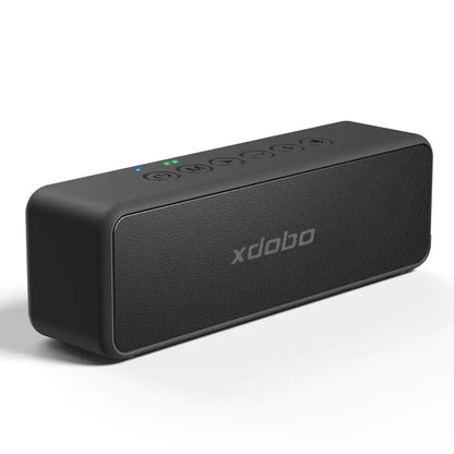 A black rectangular Bluetooth speaker with rounded edges showing the Xdobo branding. The speaker has control buttons on top and a mesh speaker grille on the front.