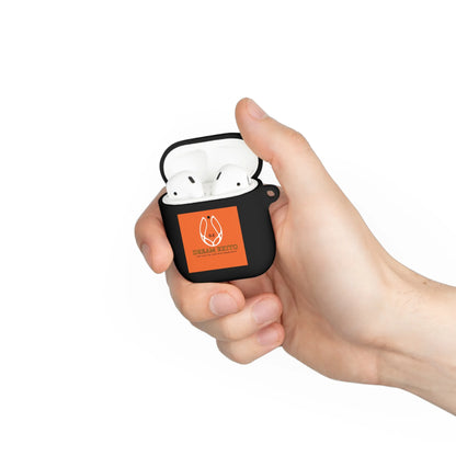 A hand holding an open black earbud case with white earbuds inside and an orange sticker on the front.