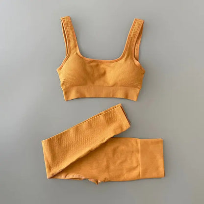 A light yellow-colored ribbed workout set with sports bra top and high-waisted shorts against gray background