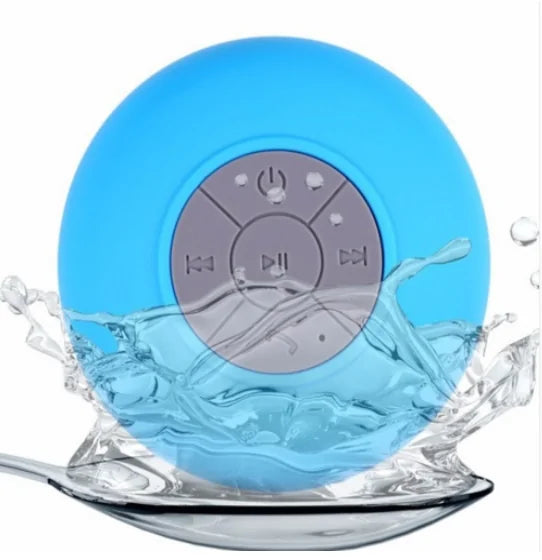 Blue waterproof speaker with control buttons, splashing water around it.