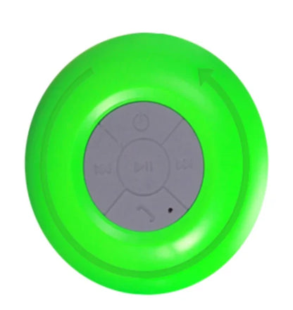 Circular green speaker with a central control panel.