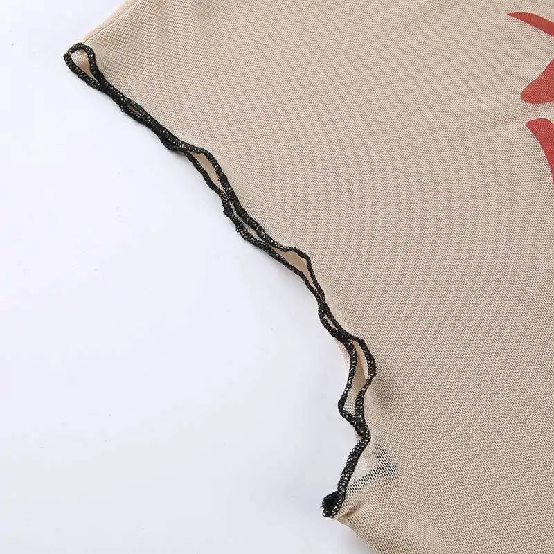 Close-up detail of beige mesh fabric with delicate black wavy trim edging against white background