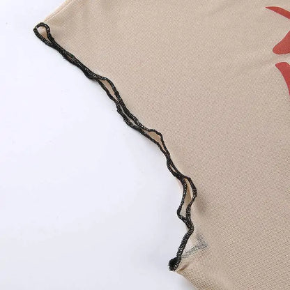 Close-up detail of beige mesh fabric with delicate black wavy trim edging against white background