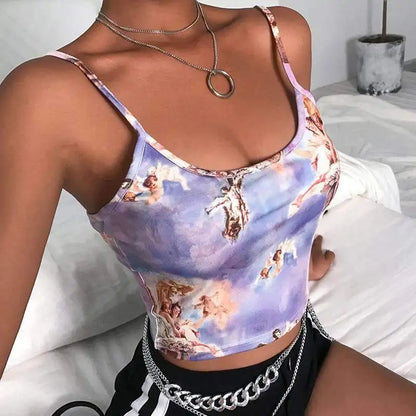 Close-up of the crop top worn with silver chain necklaces, showing detailed print of classical artwork 