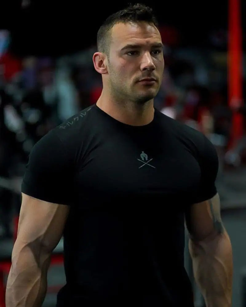 Close-up portrait of athletic model in black fitted t-shirt with minimalist warrior logo