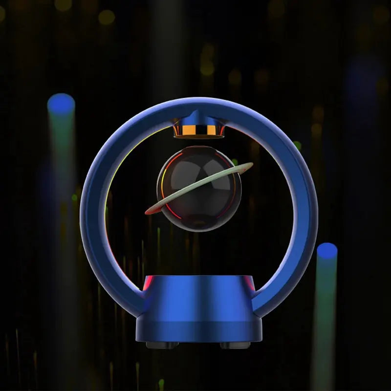 Dark blue circular speaker with suspended black sphere and ring in center against blurred background with light bokeh effects