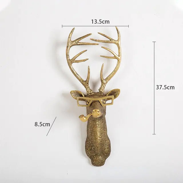 Decorative deer head wall hook with antlers, glasses, and a pipe, displayed against a white background with measurements