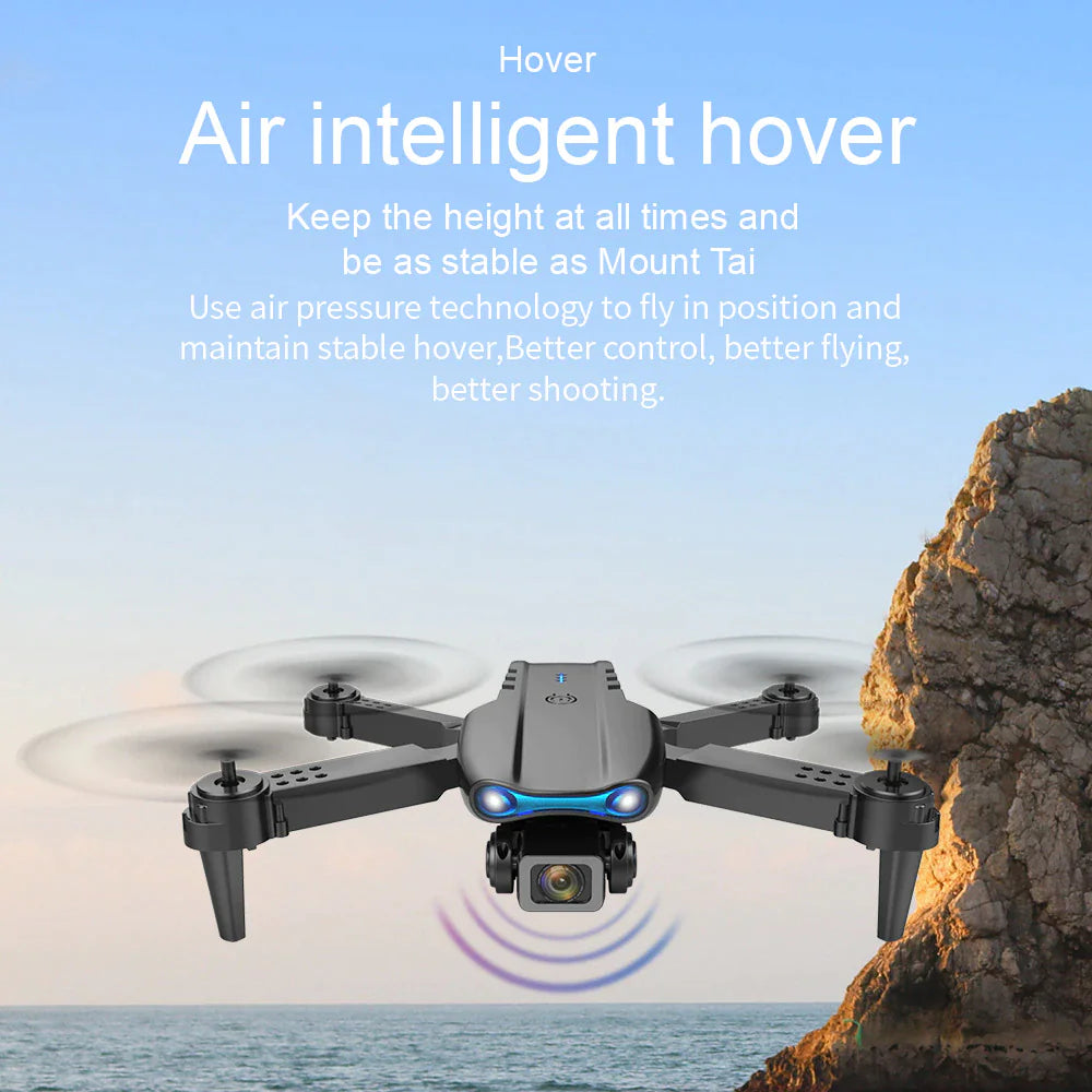 Drone hovering near rocky cliff demonstrating stable air pressure technology with ocean background view