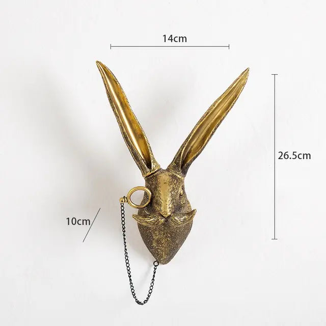 Gold-colored hare head wall hook with monocle and chain, annotated with measurements