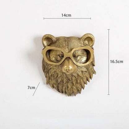 Gold bear head sculpture with glasses, dimensions marked 14 cm wide, 16.5 cm tall, and 7 cm deep