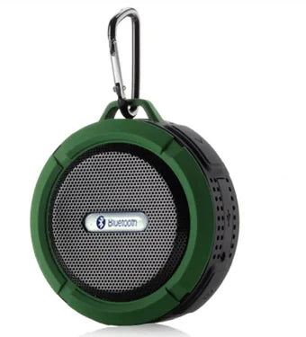 Green portable Bluetooth speaker with carabiner clip shown at an angle