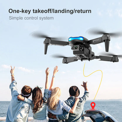 Group of friends raising hands joyfully as drone flies above, showcasing one-key takeoff/landing feature