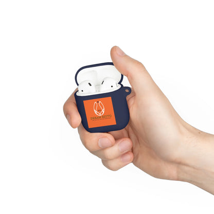 Hand holding a dark blue earbud case with an orange label