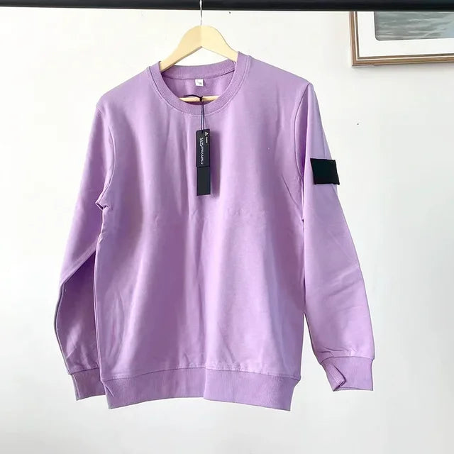 Lavender purple crewneck sweatshirt with black arm patch and price tag, displayed on wooden hanger