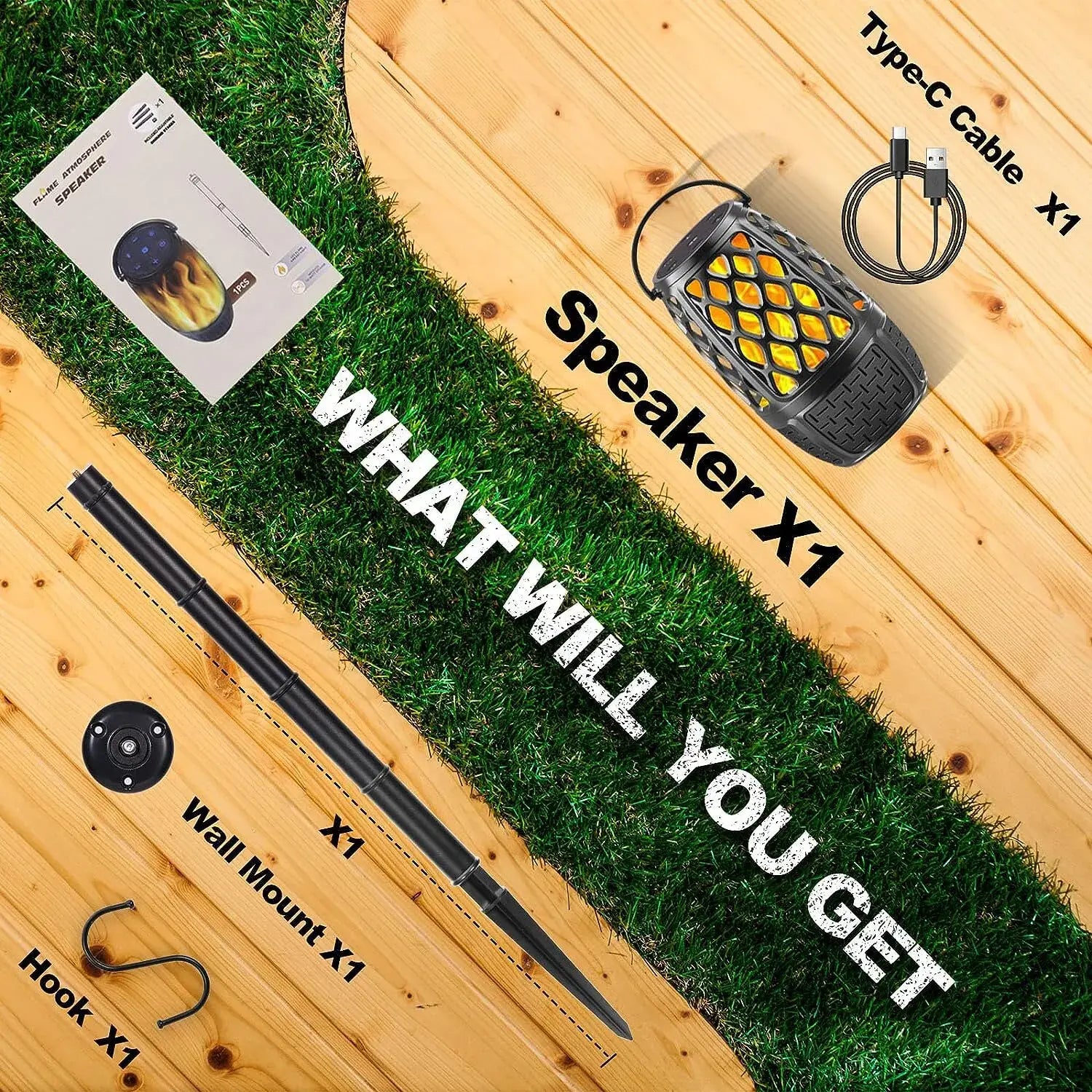 Layout of a speaker, Type-C cable, wall mount, hook, and manual on a wooden and grassy surface.