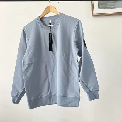 Light gray casual sweatshirt with black price tag and arm patch, displayed on wooden clothes hanger