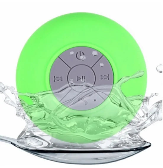 Lime-green circular speaker with a grey control panel, splashed by water.