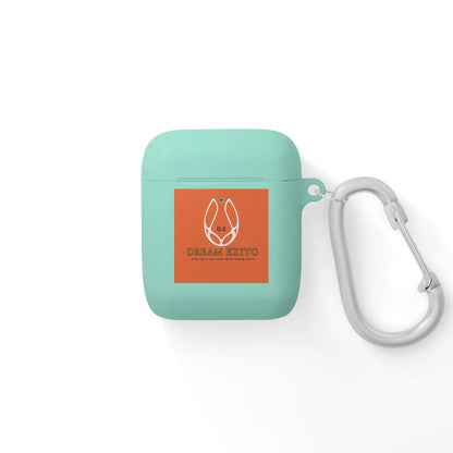 Mint-green earbud case with an orange label and carabiner.