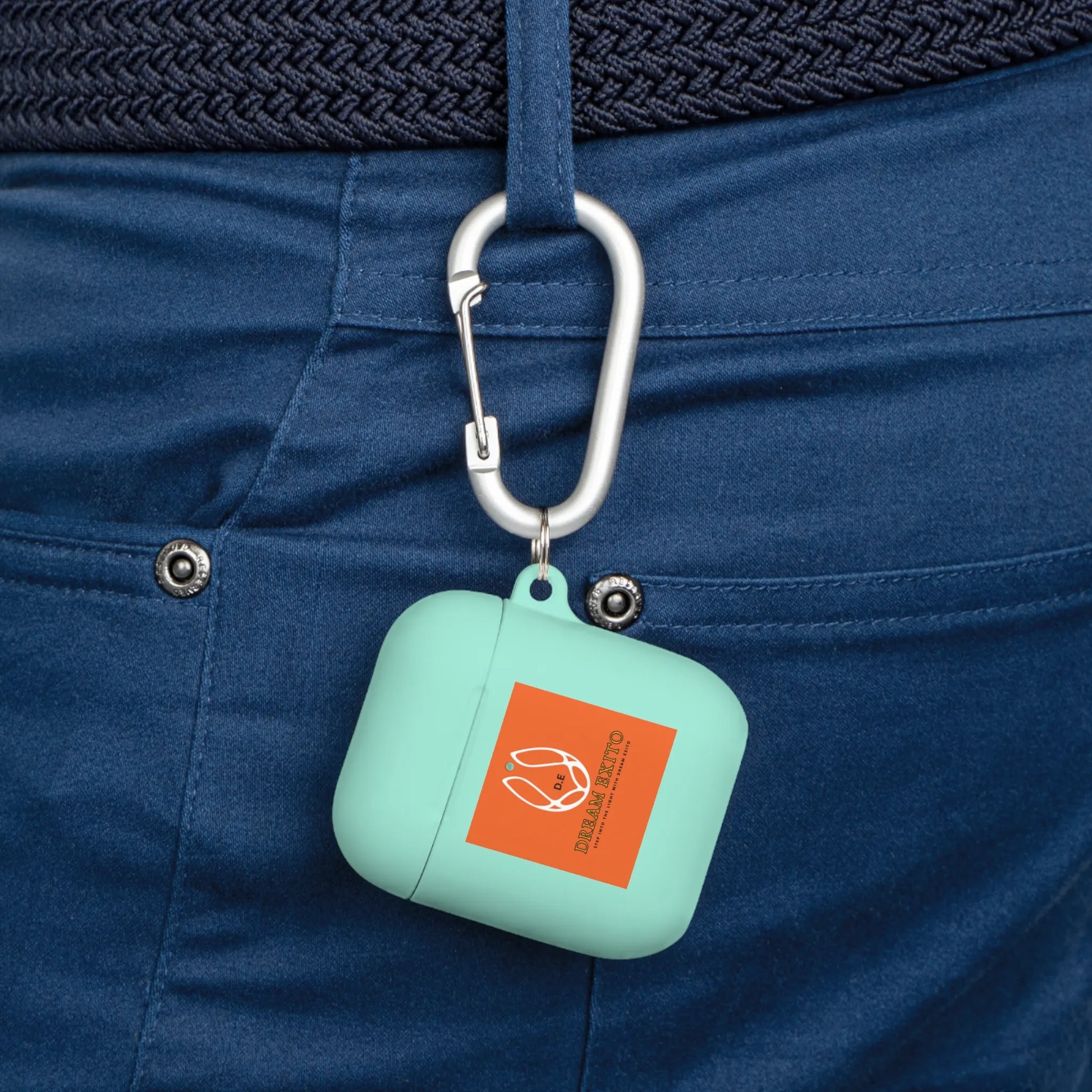Mint green case on a carabiner attached to blue pants, featuring an orange label