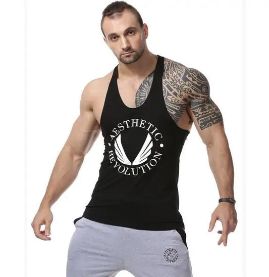 Muscular model in black tank top with 'Aesthetic Revolution' logo, showing tribal arm tattoo and gray pants