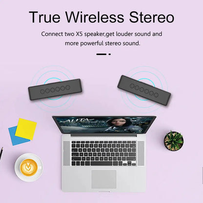 Overhead view of a laptop with two Xdobo speakers wirelessly connected above it, demonstrating true wireless stereo functionality.