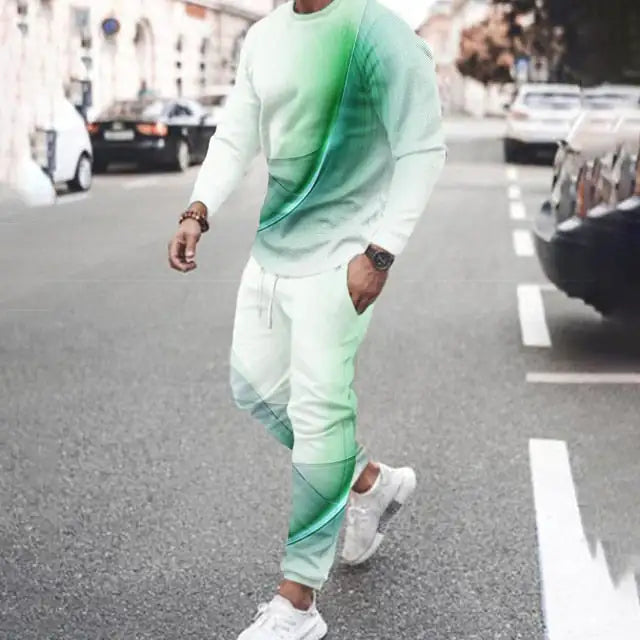 Person wearing mint green gradient tracksuit with curved design pattern, paired with white sneakers on city street