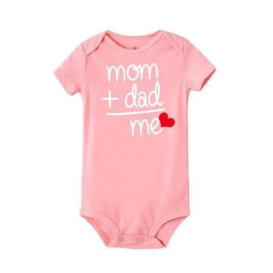 Pink baby bodysuit with white text reading "mom + dad = me" and small red heart accent