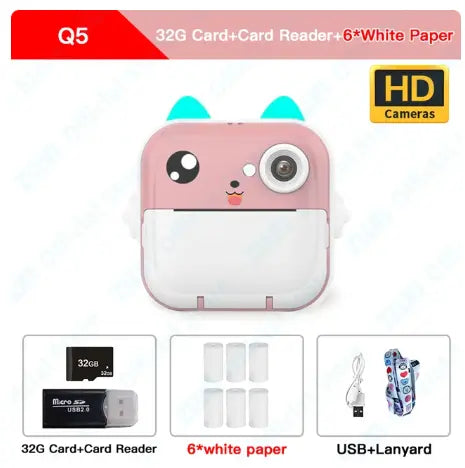 Pink cat-shaped instant camera with 32GB card, card reader, white paper, and USB accessories
