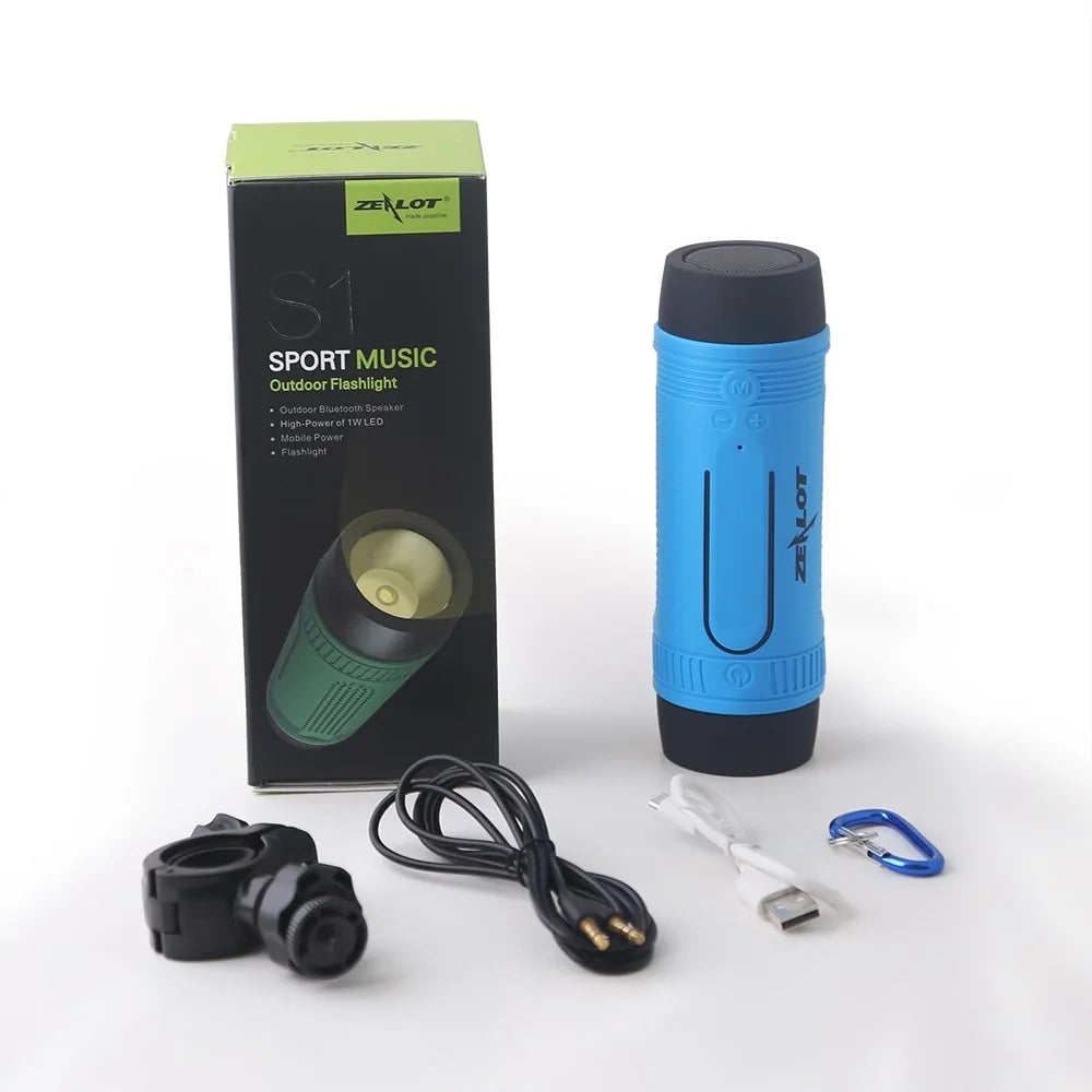 Product package contents showing blue Zealot speaker, mounting accessories, cables, and black retail box with green accent