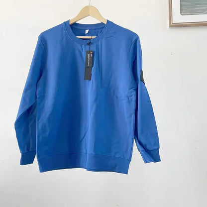 Royal blue casual sweatshirt with black arm patch and price tag, photographed on white background