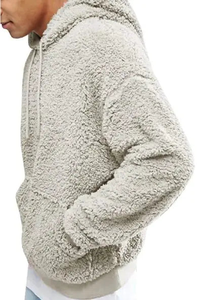 Side view of a grey-colored teddy fleece hoodie with soft textured fabric and ribbed hem detailing