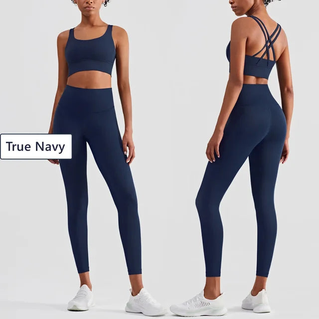 True Navy fitness set featuring cross-back sports bra and high-waisted compression leggings