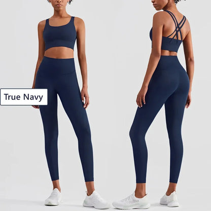 True Navy fitness set featuring cross-back sports bra and high-waisted compression leggings
