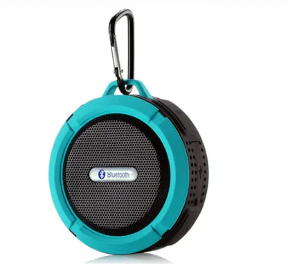 Turquoise portable Bluetooth speaker with carabiner clip shown at an angle