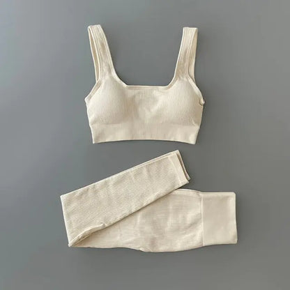 White -colored ribbed workout set with sports bra top and high-waisted shorts against gray background