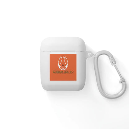 White AirPods case with a carabiner and an orange logo sticker reading "DREAM EXITO.