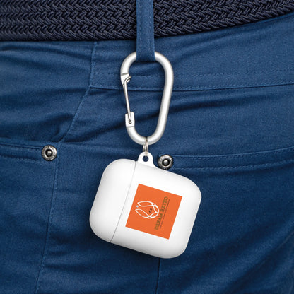 White AirPods case with an orange label attached to blue pants by a silver carabiner.