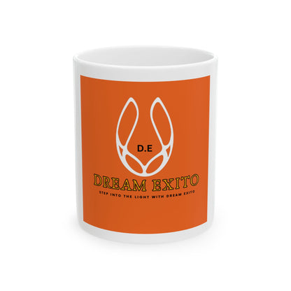 White ceramic mug with orange background featuring "Dream Exito" logo and slogan "Step into the light with Dream Exito."