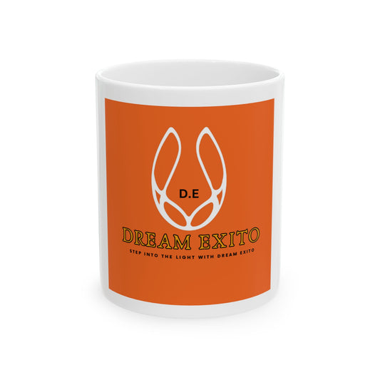 White ceramic mug with orange background featuring "Dream Exito" logo and slogan "Step into the light with Dream Exito."