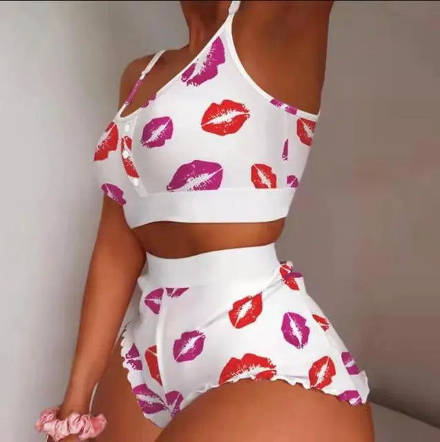 White two-piece loungewear set decorated with red and pink lip prints, featuring crop top and high-cut shorts