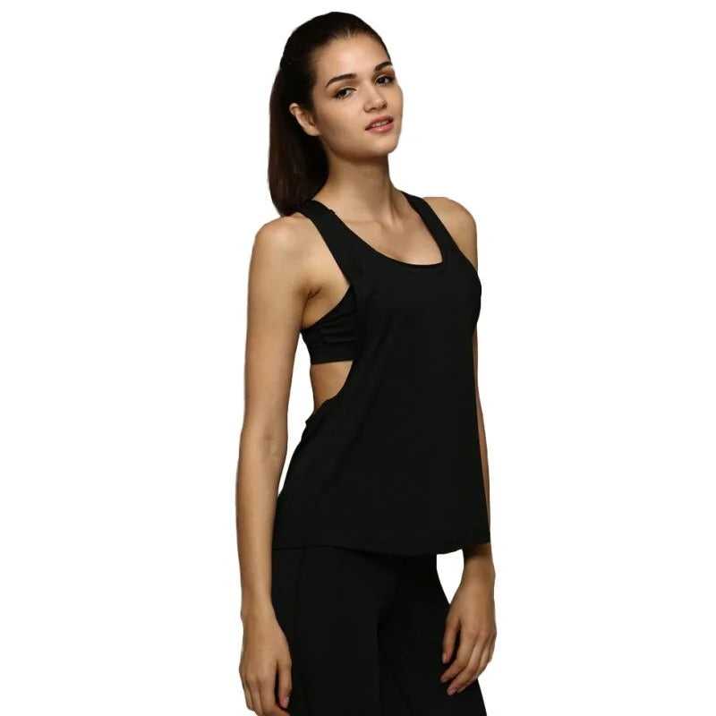 Woman wearing all-black athletic outfit with racerback tank top, side view showing cutout detail